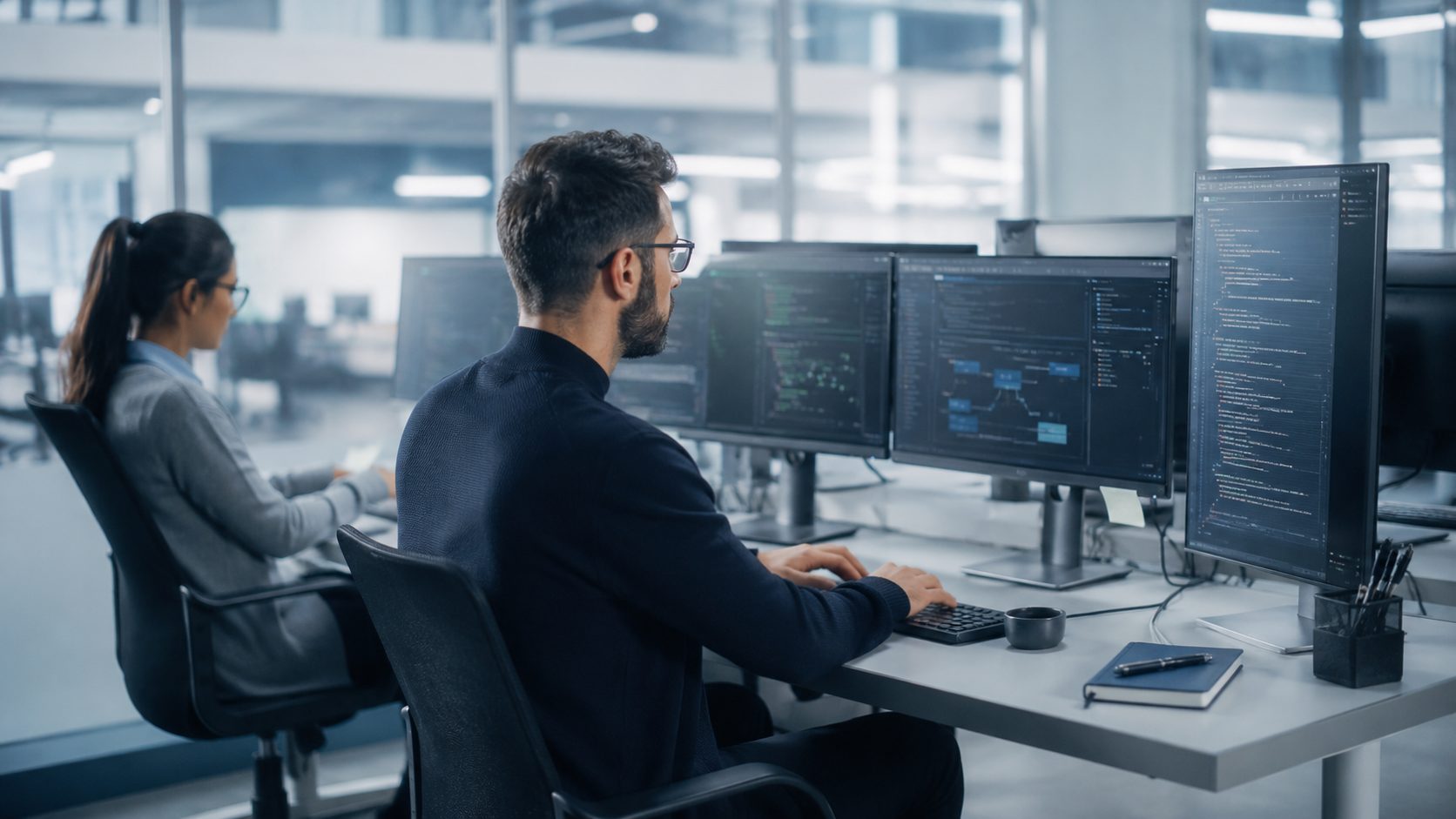 Developers writing software on multiple monitors